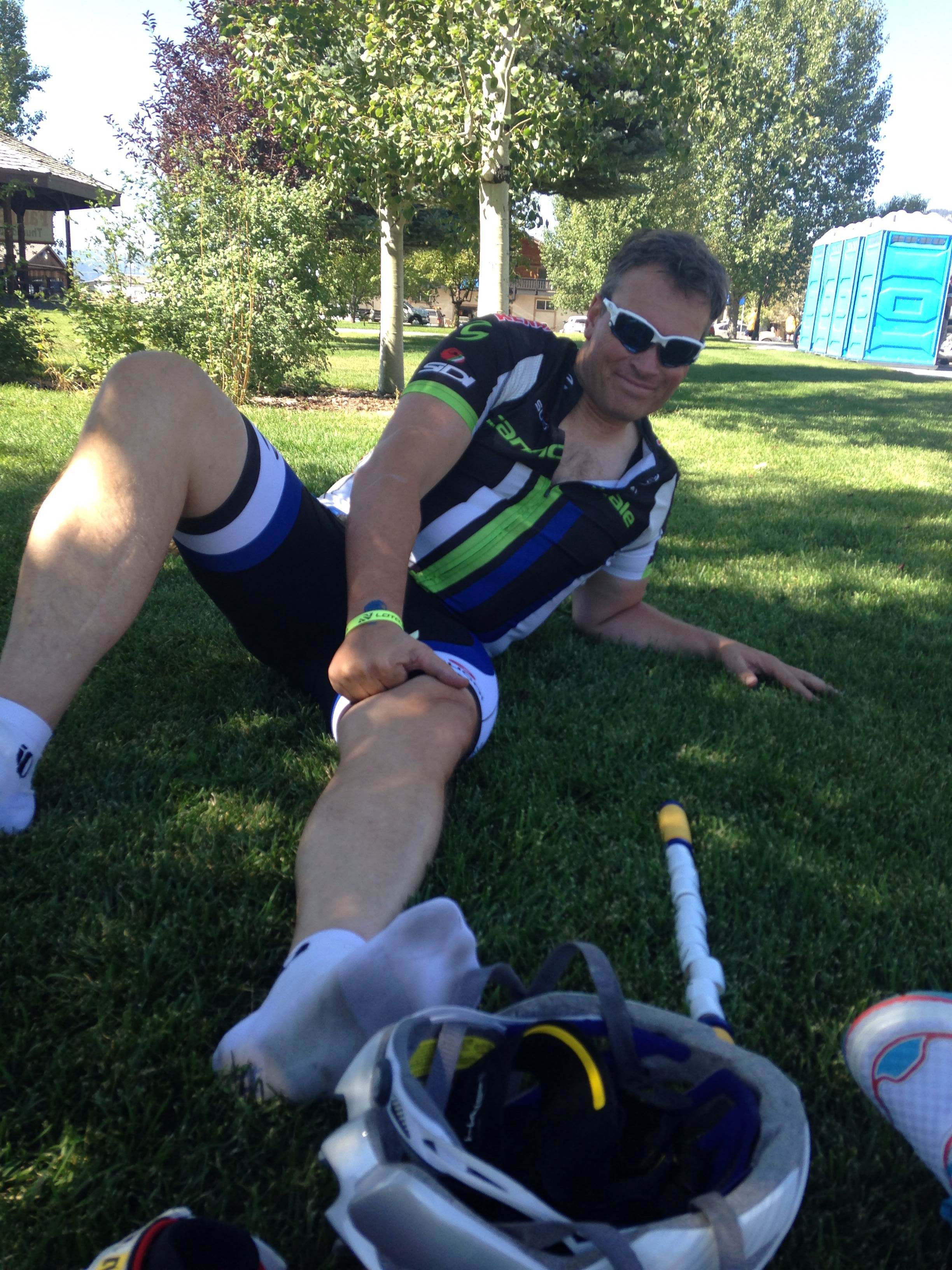 AFTER THE RACE, cyclist Kyle Morris works cramps out of his legs.