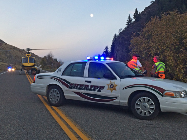 Deputies block the road to Blacksmith Fork Canyon as firejumpers prep their helicopter. (Erin West photo)