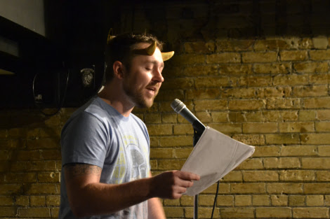 Justin Peterson, sporting horns for Spookfest, performs an original poem. 