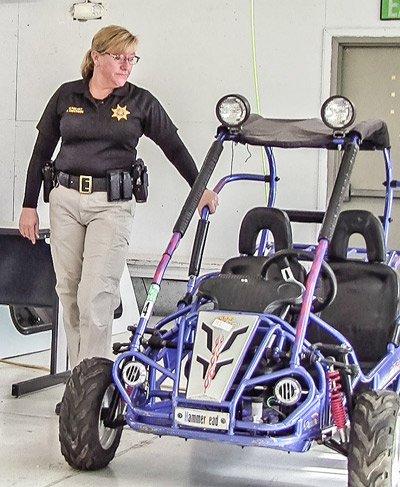 Sheriff’s Sgt. Anderson inspects a confiscated dune bugger before the auction. (Amanda Wray photo)