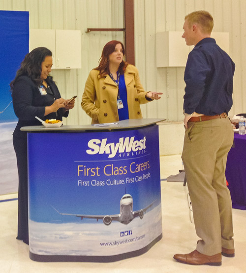SkyWest recruiters talk to a prospective pilot trainee at USU’s first-ever aviation fair. (Amanda Wrap photo) 
